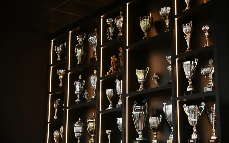 Rows of football trophies on museum shelves